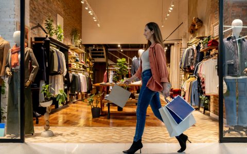 Happy woman walking at the shopping mall carrying bags